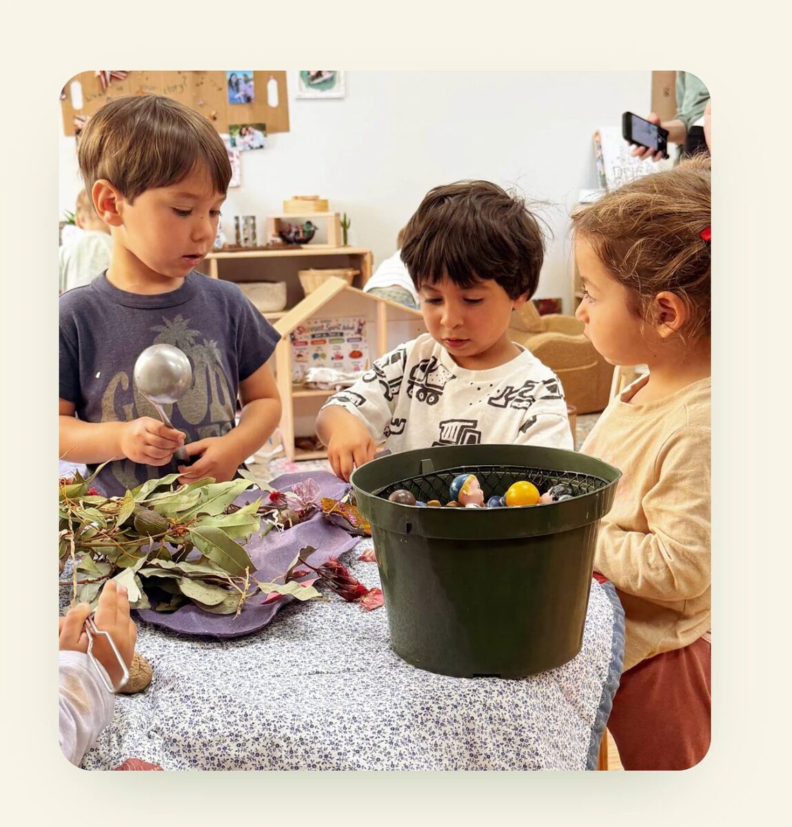 Children exploring nature materials together at PJECC